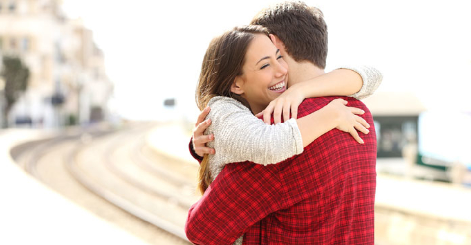 Couple Hugging Happy In A Train Station